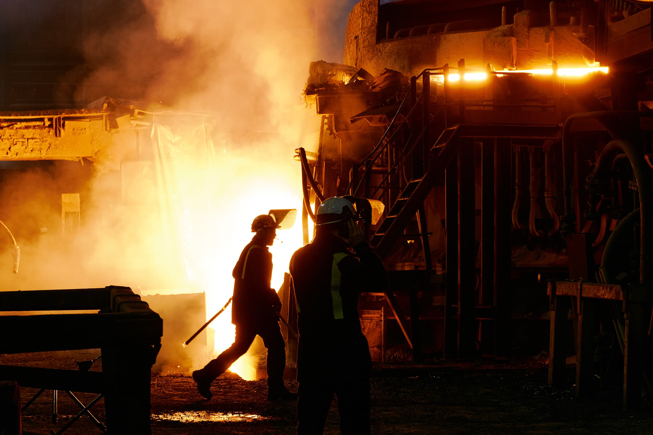 Workers in a foundry or steelworks with molten metal