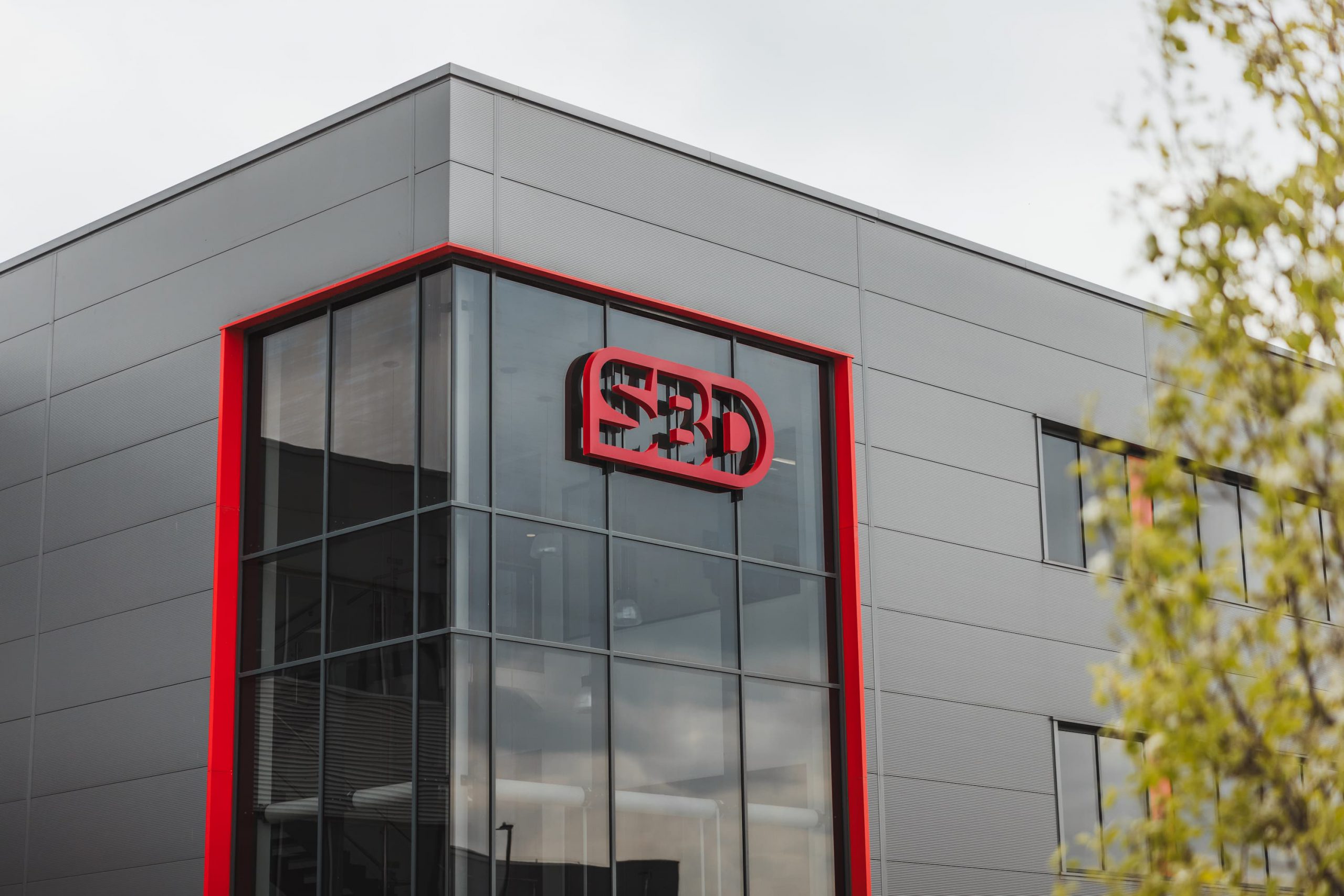 Exterior of an industrial or commercial building with SBD branding